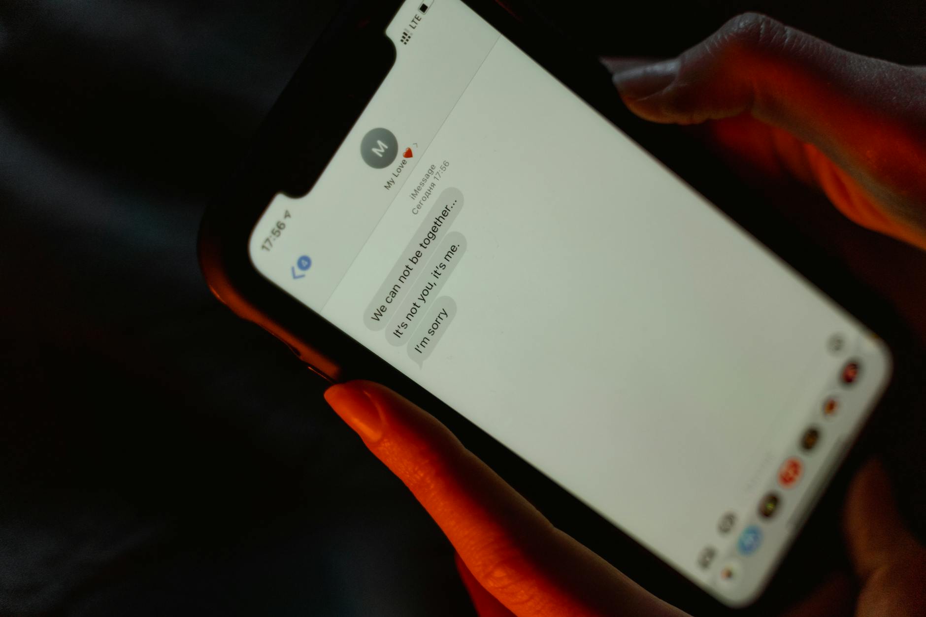person holding and reading a text message on a mobile phone